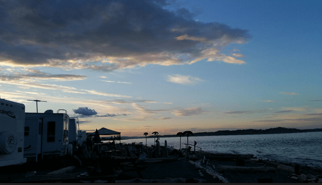 RV sites at Beachcomber RV Park during a dramatic shoreline sunset
