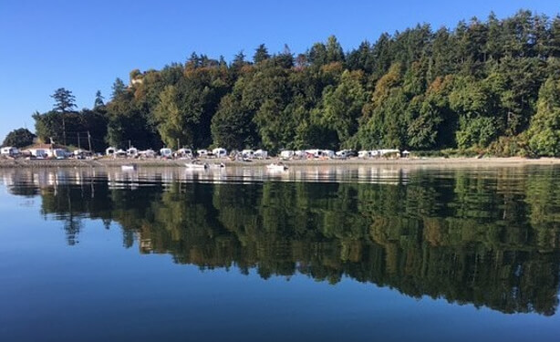 Beachcomber RV Park shoreline reflected in calm water