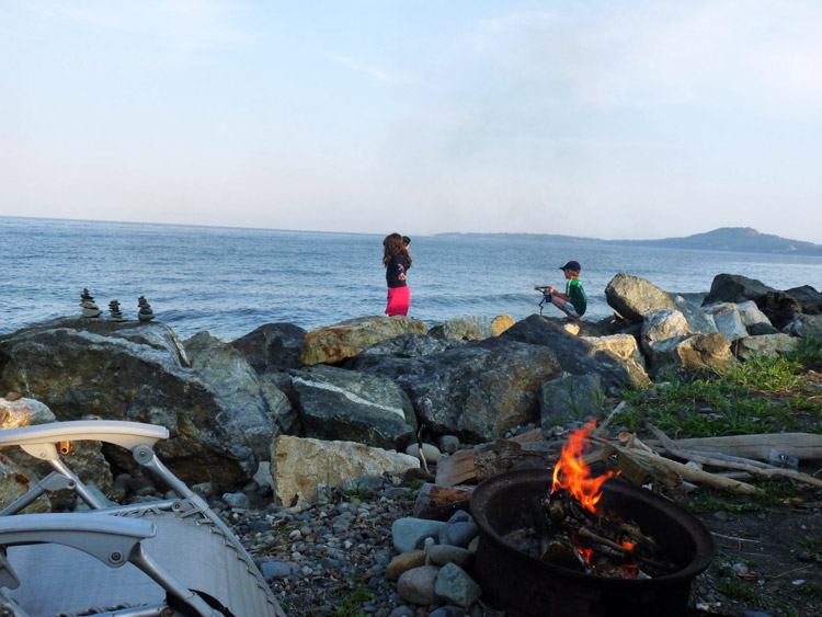 Family campfire beside the beach at Beachcomber RV Park